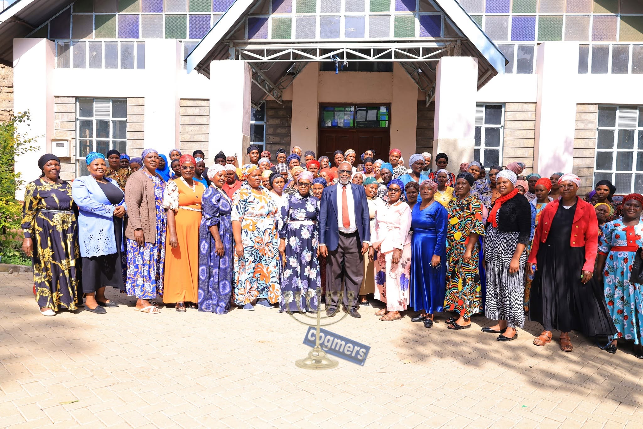 MEWAK members gathered together outside the church